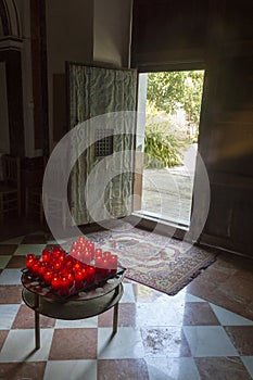 Candles as an offering next to the entrance of the religious temple