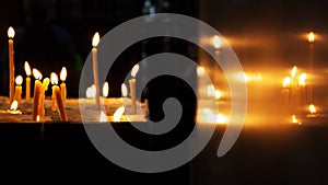 Candles Burning in a Church and Reflecting out of Wall