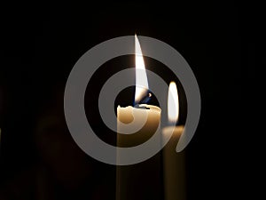 Candles burning in darkness photo