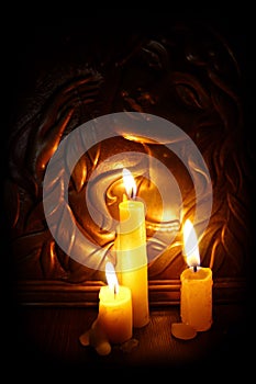 Candles burning in darkness