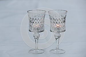 Candles burning in glass goblets