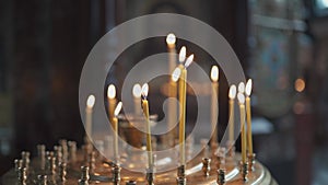 Candles burning in orthodox church. Vladimirsky Cathedral in Kiev. Candlestick with burning candles in the church