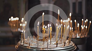 Candles burning in orthodox church. Vladimirsky Cathedral in Kiev. Candlestick with burning candles in the church