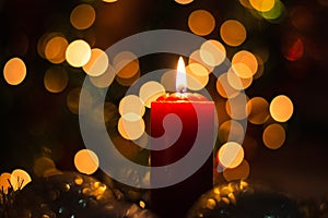 Candles and Christmas decorations on dark background with lights