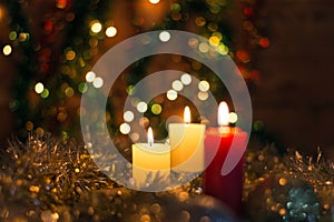 Candles and Christmas decorations on dark background with lights