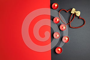 Candles and decorative hearts on a red-gray background.