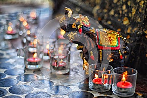 Candles with an elephant sculpture.