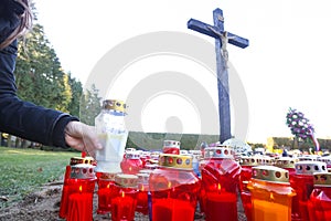 Candles on floor beneath cross