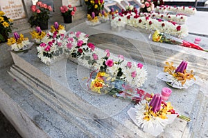 Candles and Flowers over Grave in The Annual Blessing of Graves at Ratchaburi Province, Thailand