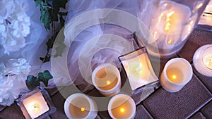 Candles in glass flasks at the evening celebration at the festive table. Wedding decor in the restaurant.