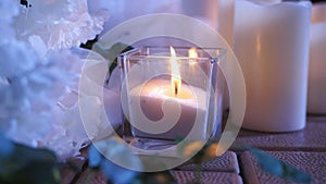 Candles in glass flasks at the evening celebration at the festive table. Wedding decor in the restaurant.