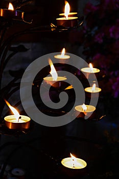 Candles glow in the church, mystery and intimacy