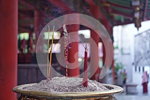 Candles and incense sticks burning in a chinese temple