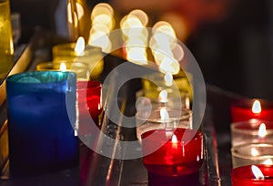Candles inside a church. Sensation of religiosity and tranquility. Bokeh lights as space for text