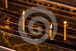 The candles lighen in front of the old temple in Thailand