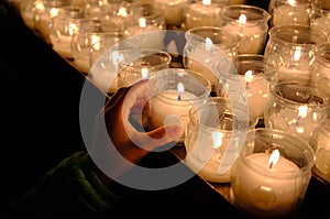 Candles lighting church and children offering coin