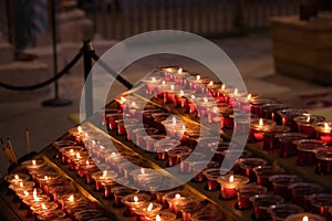 Candles lit by parishioners in the cathedral of Santiago de Compostela. Concept pilgrim, journey, road, religion