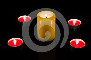 Candles are lit on the table, dark background. Topp view.