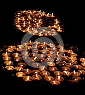 Candles lit with the warm flame during the religious ceremony