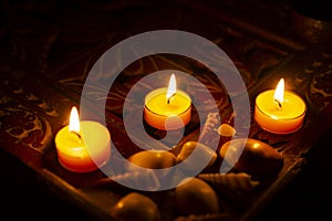 Candles are lit on a wooden table