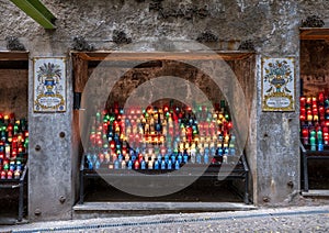 Candles and mosaic tiles along the Ave Maria Way in the Basilica at Santa Maria de Montserrat Montastery in Barcelona, Spain. photo