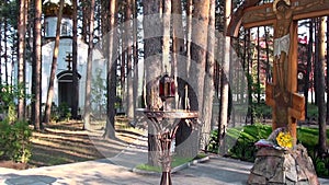 Candles near cross with crucifix in place of execution of Elizabeth Feodorovna.
