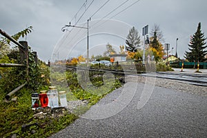 Candles next to a train crossing