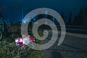 Candles next to a train crossing