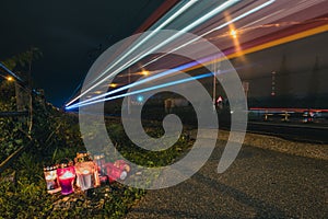 Candles next to a train crossing at night