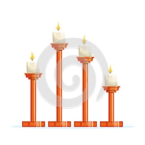 Candles placed on different heights of wooden candlesticks