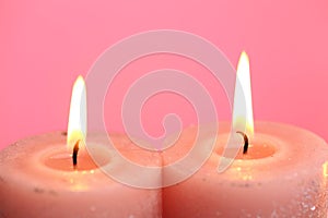 Candles set. Burning candles on a pink background. Festive shiny candles. Flame candles close-up.Religion and culture