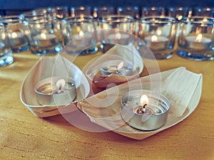 Candles in small glasses and boats during the vigil ceremony and prayer