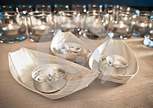 Candles in small glasses and boats during the vigil ceremony and prayer