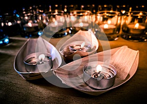 Candles in small glasses and boats during the vigil ceremony and prayer