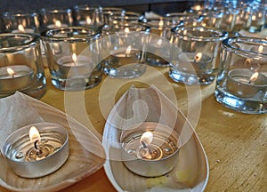 Candles in small glasses and boats during the vigil ceremony and prayer