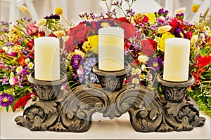 Candles on a stand and floral arrangement