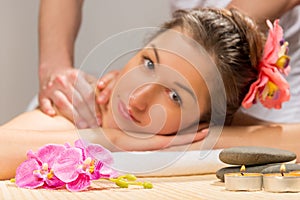 Candles, stones and flowers for spa treatments and the girl`s