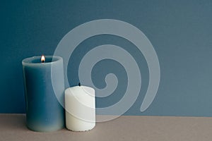 Candles on table. navy blue wall background
