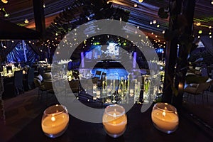 Candles and tulip flowers decoration at night, indoor luxury wedding with low light romantic ambient