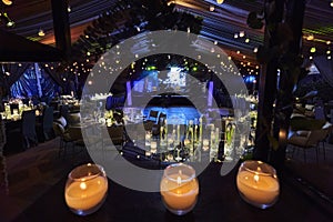 Candles and tulip flowers decoration at night, indoor luxury wedding with low light romantic ambient photo