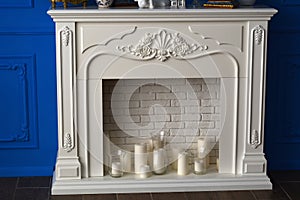 Candles and white fireplace in the room