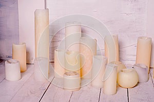 Candles on white hardwood. Studio shot