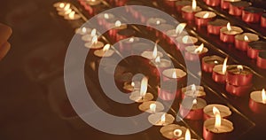 Candles and woman hands praying showing off on camera