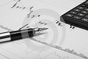 Candlesticks chart, pen and calculator