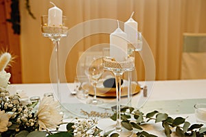 Candlesticks on a festive wedding table. Elegance wedding decor.