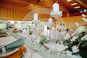 Candlesticks on a festive wedding table. Elegance wedding decor.