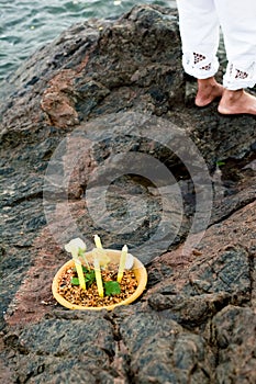 Candomble admirers are seen on top of a rock on the beach, paying homage to Iemanja with gifts