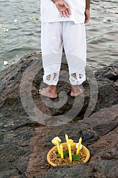 Candomble admirers are seen on top of a rock on the beach, paying homage to Iemanja with gifts