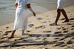 Candomble members are seen walking on the sands of Rio Vermelho beach in the city of Salvador, Bahia