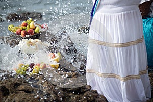 Candomble people are offering food to iemanja during a party on Rio Vermelho beach. Salvador, Bahia